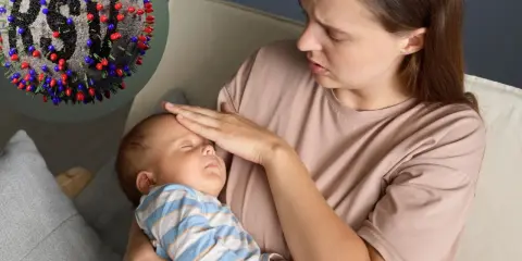 Zmartwiona mama sprawdza gorączkę u śpiącego niemowlaka. Obok wirus RSV, który może powodować groźne objawy u dzieci.